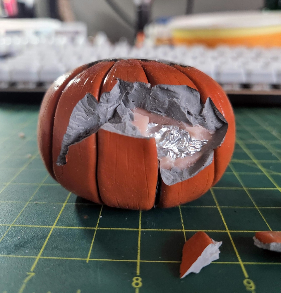Removing the broken pieces from Mr. Pumpkin's head